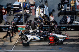 Graham Rahal's pit crew running to address the car in the pit.