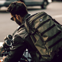 Man wearing the the OGIO ALPHA 525 Backpack on a motorcycle