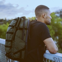 Guy looking over bridge with Olive OGIO ALPHA Convoy 525