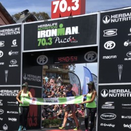 OGIO Racer Alicia Kaye crossing finish line at 2019 Ironman 70.3 Pucon Chile